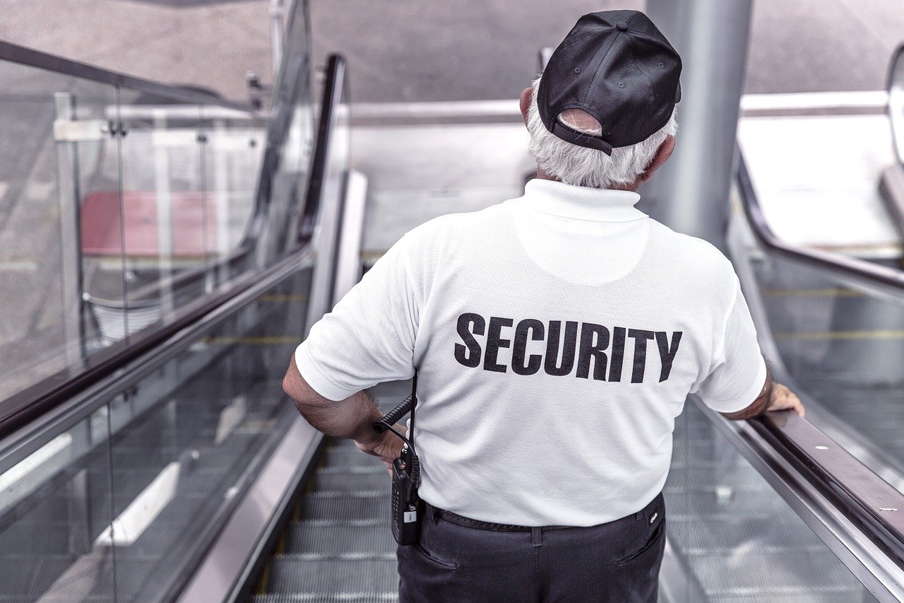 agent de sécurité sur un escalator